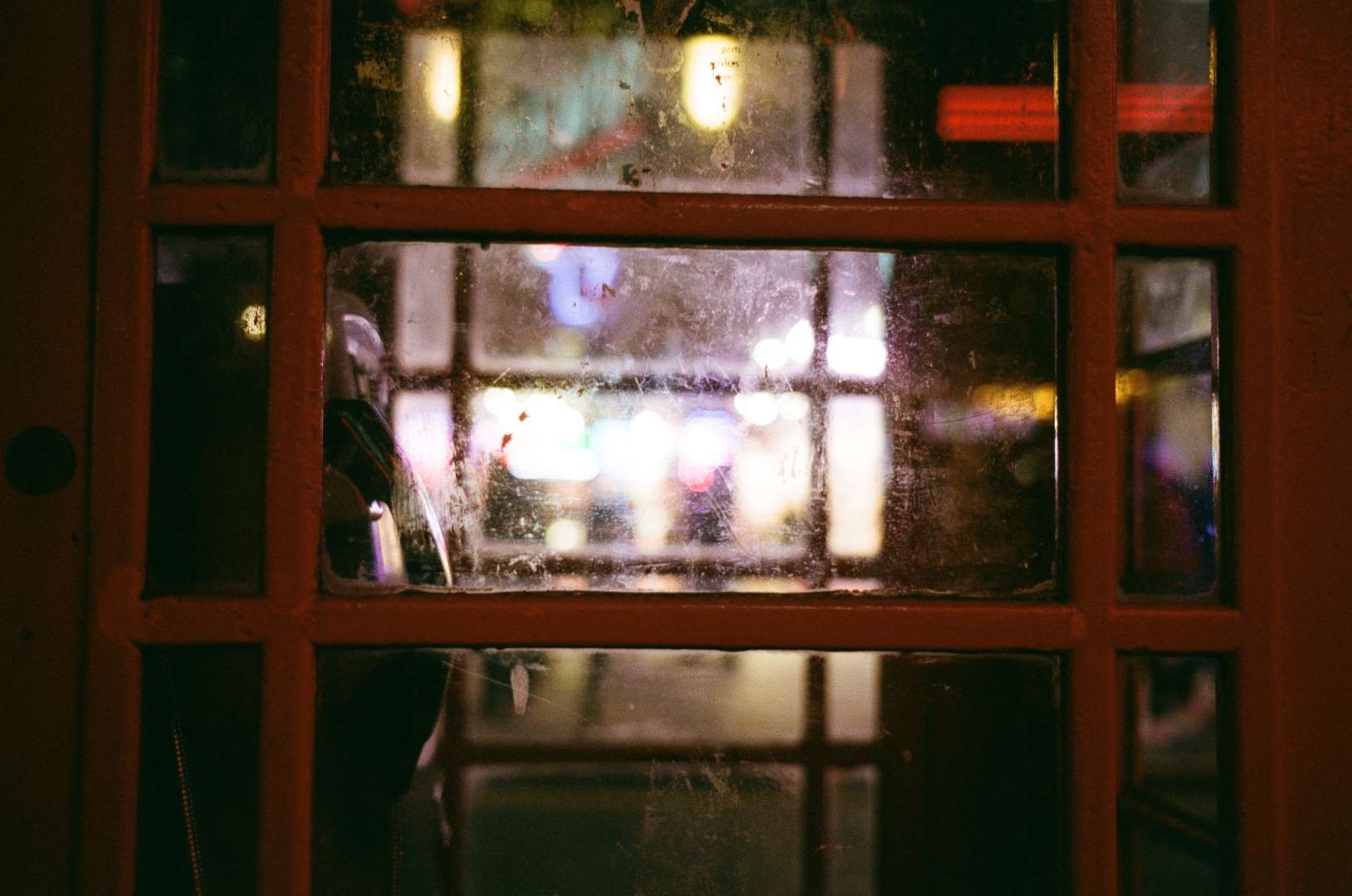 A colour photograph of a British phone booth at night