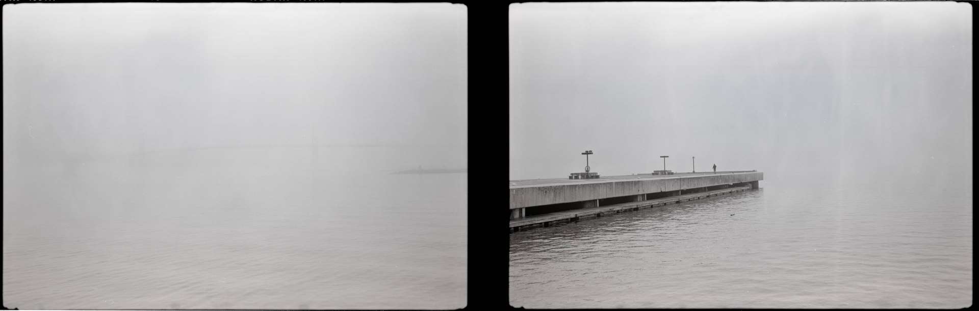 A black and white diptych photograph of a Halifax Harbour with a suspension bridge shrouded in fog on the left panel and a man standing at the end of a pier on the right