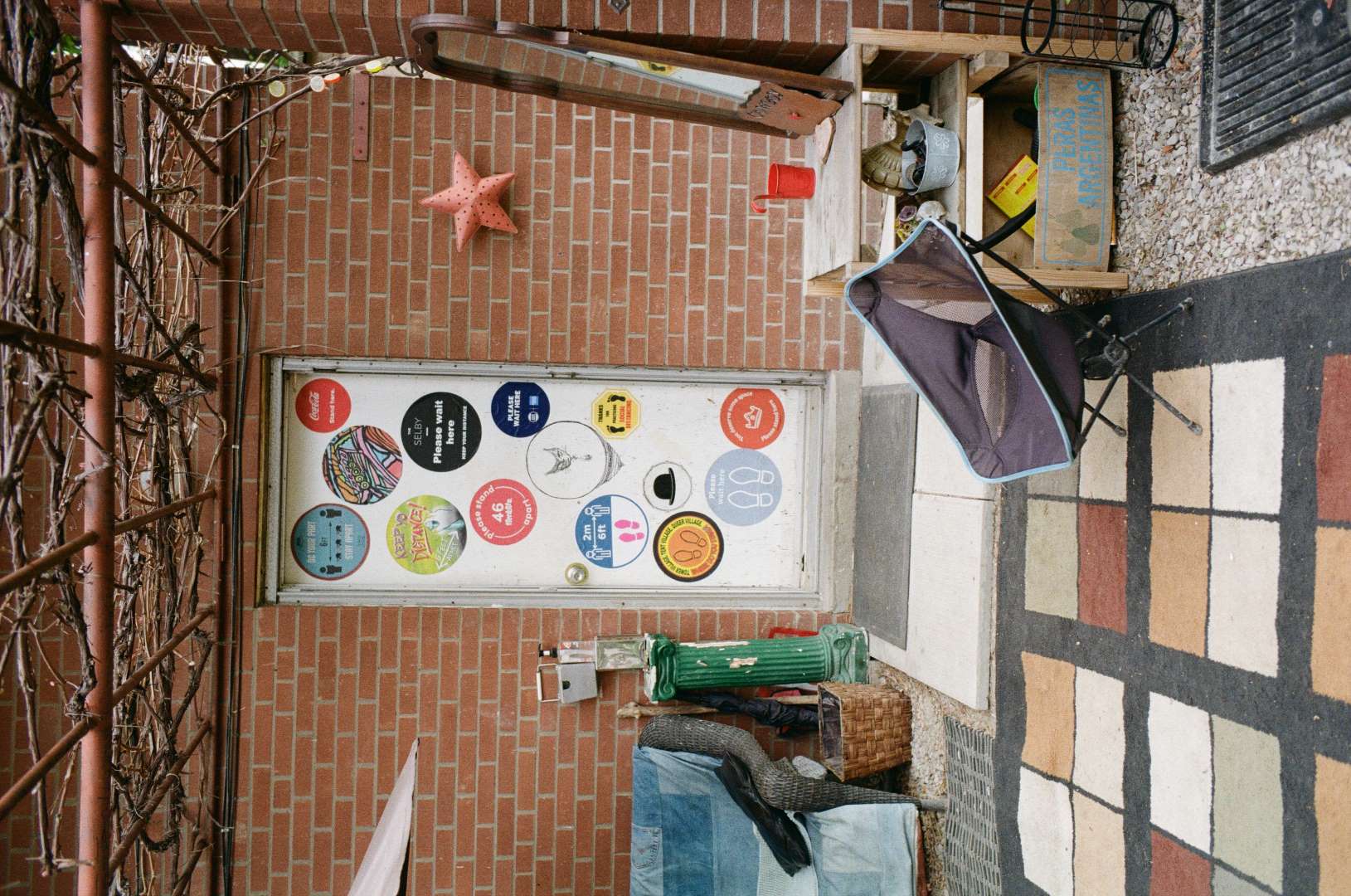 A colour photograph of a backdoor with 2 meter spacing indicators from early in the pandemic